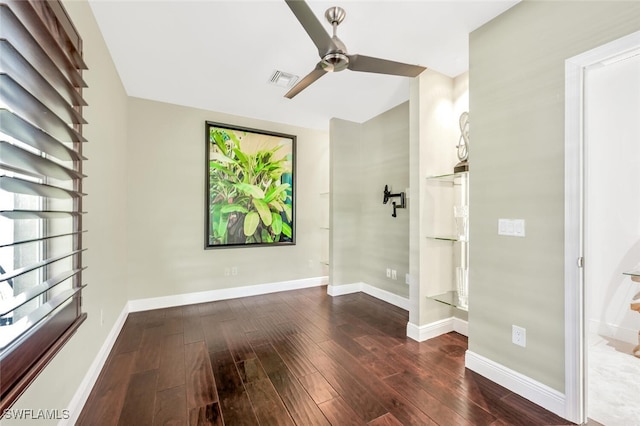 spare room featuring ceiling fan and dark hardwood / wood-style flooring