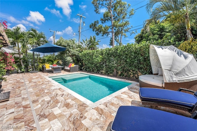 view of swimming pool with outdoor lounge area and a patio