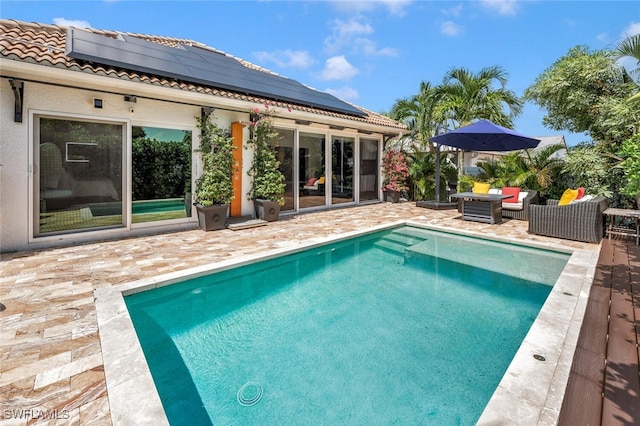 view of pool with an outdoor living space and a patio area