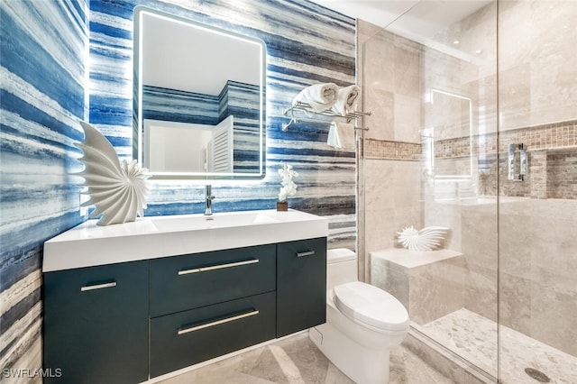 bathroom with vanity, toilet, and a shower with door