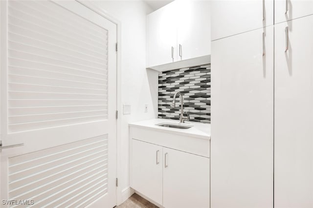 bathroom with decorative backsplash and vanity