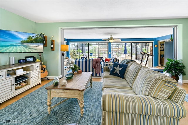 living room featuring wood-type flooring and ceiling fan