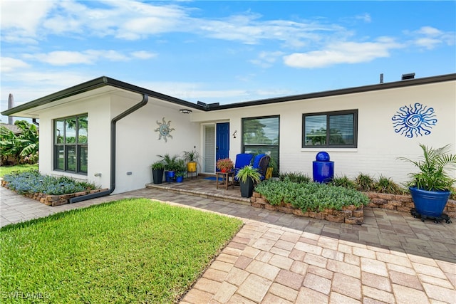 exterior space featuring a patio area and a front lawn