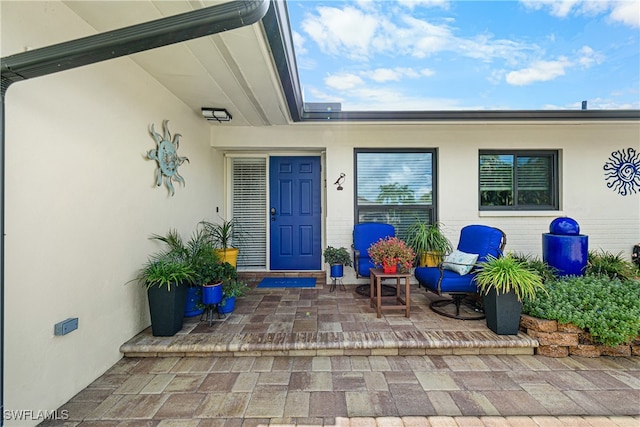 doorway to property with a patio area