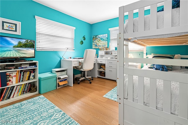 bedroom featuring wood-type flooring and multiple windows