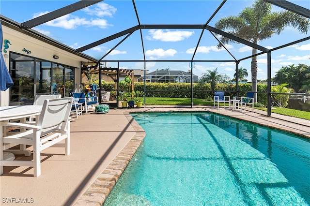 view of pool with a lanai and a patio area