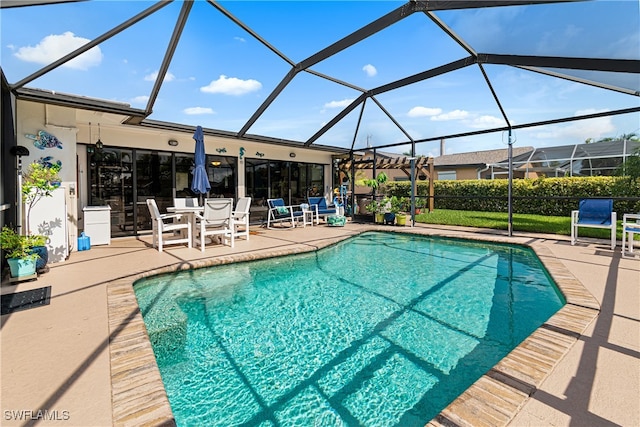 view of swimming pool featuring a lanai and a patio area