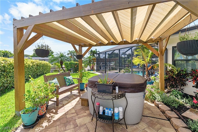 view of patio featuring a lanai and a hot tub