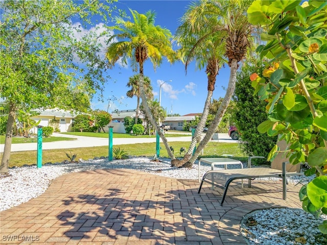 surrounding community featuring a lawn and a patio