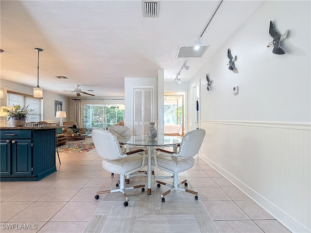 dining room featuring ceiling fan, light tile patterned flooring, and track lighting