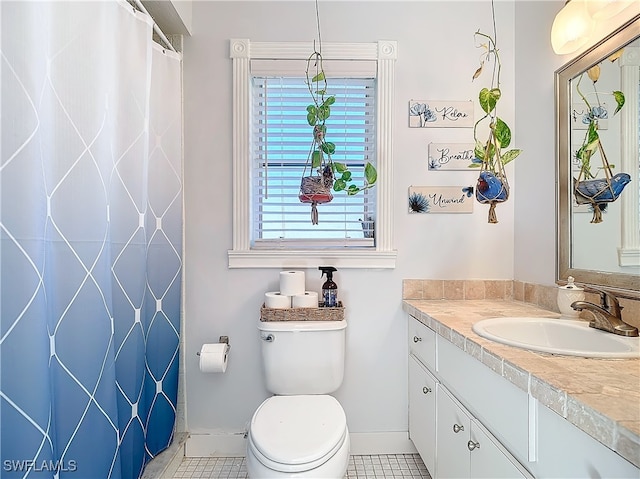 bathroom with tile patterned floors, vanity, and toilet