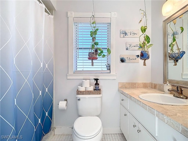 550 110th Ave N, Naples, FL 34108 - full bathroom featuring vanity, toilet, curtained shower, baseboards, and tile patterned flooring
