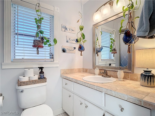 bathroom featuring vanity and toilet