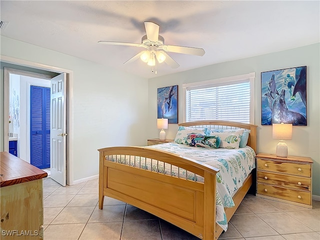 bedroom featuring a closet, ceiling fan, and light tile patterned flooring