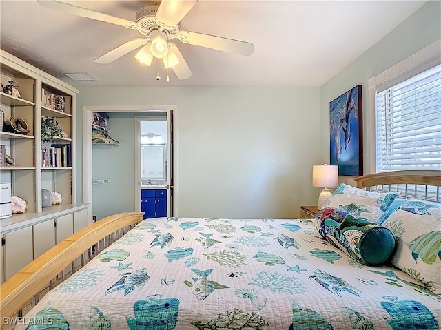 bedroom with ceiling fan, ensuite bathroom, and a closet