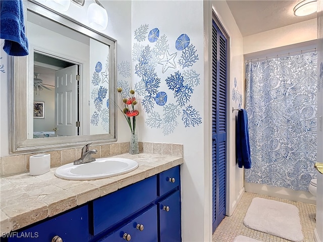 bathroom with tile patterned floors, ceiling fan, and vanity