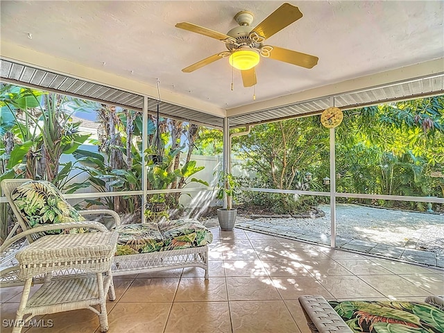 unfurnished sunroom featuring plenty of natural light and ceiling fan