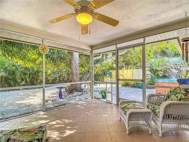 unfurnished sunroom with ceiling fan