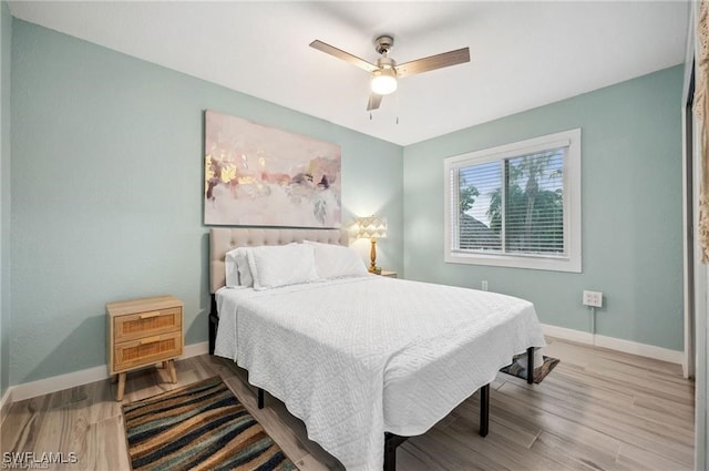 bedroom featuring hardwood / wood-style flooring and ceiling fan