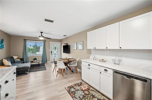 kitchen with dishwasher, visible vents, open floor plan, and white cabinetry