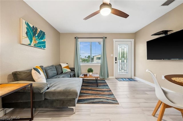 113/115 Bahia Viaduct, Fort Myers Beach, FL 33931 - living room with a ceiling fan, wood finished floors, and baseboards