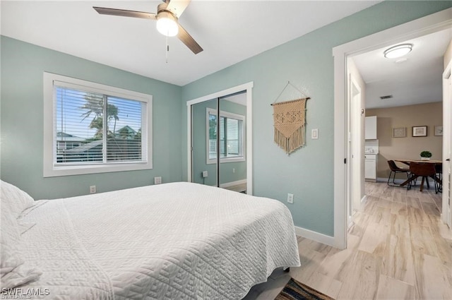 bedroom featuring light wood-type flooring, ceiling fan, and a closet