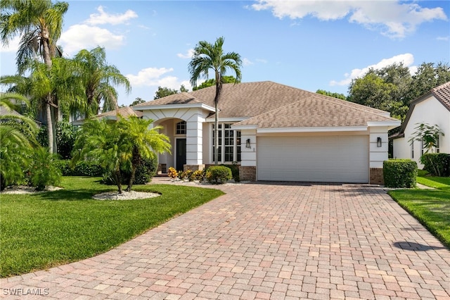 view of front of house featuring a front yard and a garage