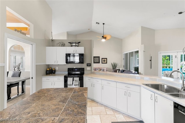 kitchen with ceiling fan, sink, black appliances, high vaulted ceiling, and white cabinetry