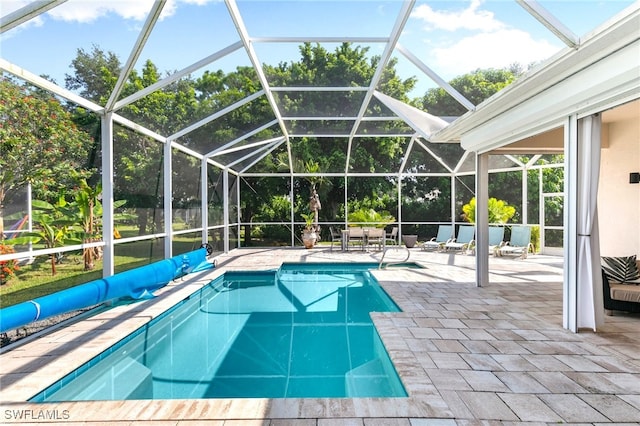 view of pool with a patio and a lanai