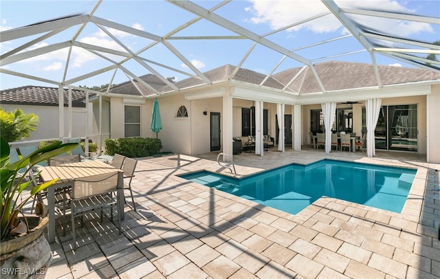 view of pool with a patio area, ceiling fan, and a lanai