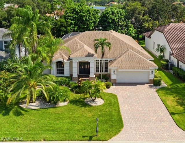 view of front of property featuring a garage and a front lawn