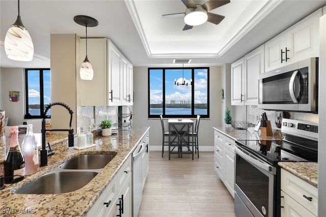 kitchen featuring plenty of natural light, white cabinets, and stainless steel appliances