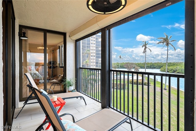 sunroom / solarium with a water view