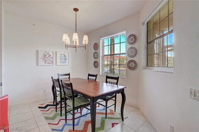 dining area featuring light tile patterned floors and an inviting chandelier