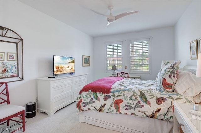 bedroom with ceiling fan and light colored carpet