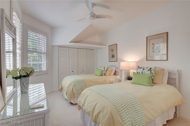 carpeted bedroom with a closet and ceiling fan