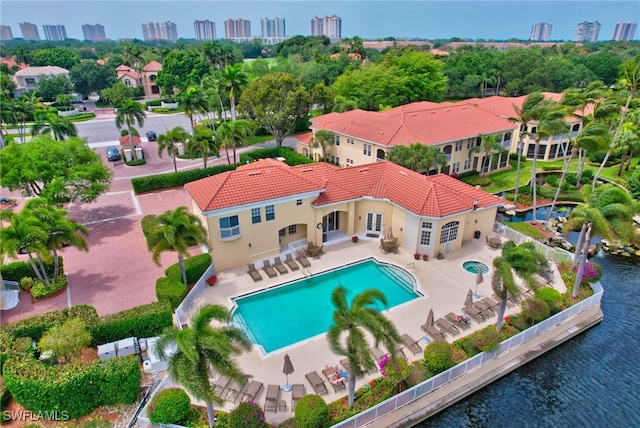 view of swimming pool with a patio and a water view