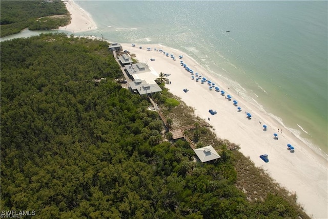 birds eye view of property with a water view and a beach view