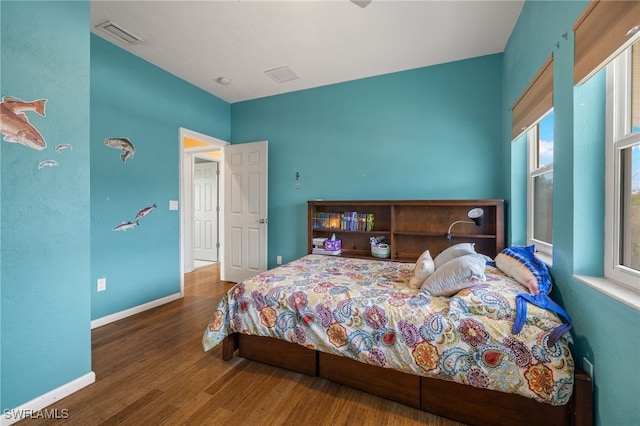 bedroom with hardwood / wood-style flooring