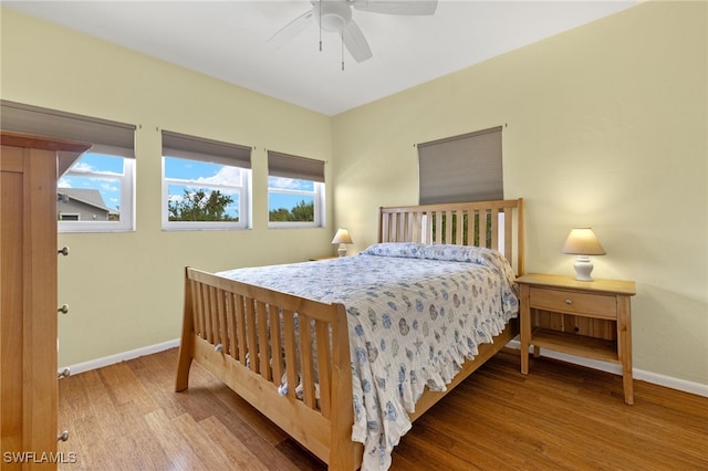 bedroom with hardwood / wood-style floors and ceiling fan