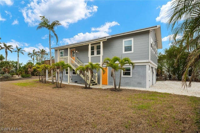 view of front of property with a garage and a front lawn