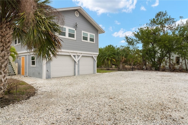 view of side of home featuring a garage