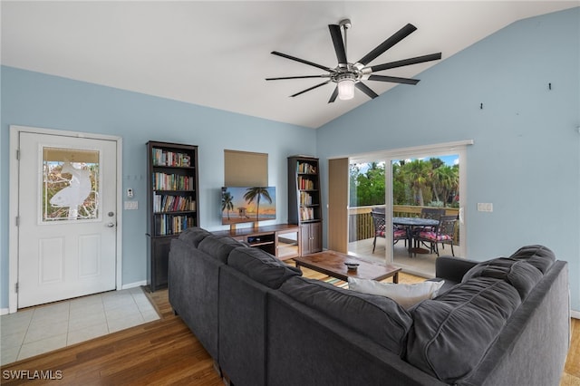 living room with ceiling fan, wood-type flooring, and lofted ceiling