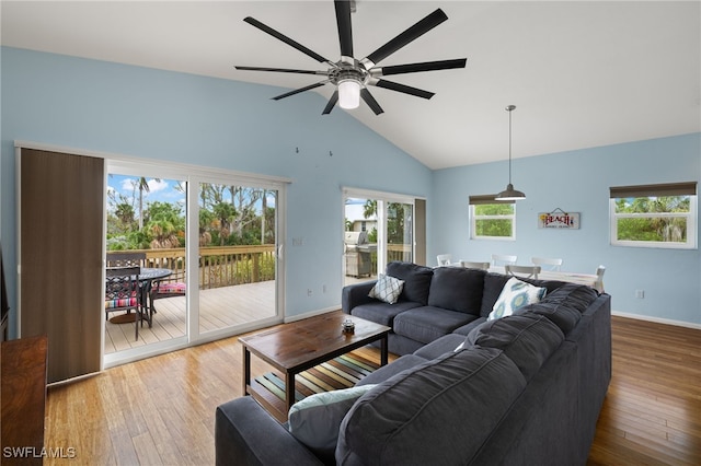 living room featuring ceiling fan, high vaulted ceiling, and wood-type flooring