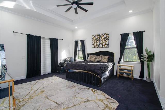 bedroom with ceiling fan, a raised ceiling, and crown molding