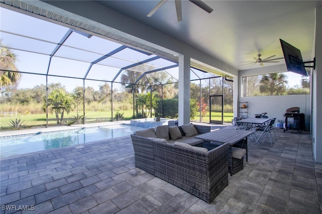 view of patio featuring outdoor lounge area, glass enclosure, and grilling area