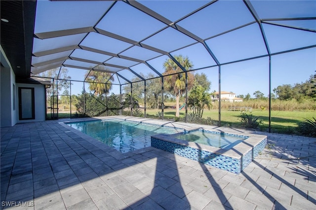 view of swimming pool featuring an in ground hot tub, glass enclosure, and a patio area