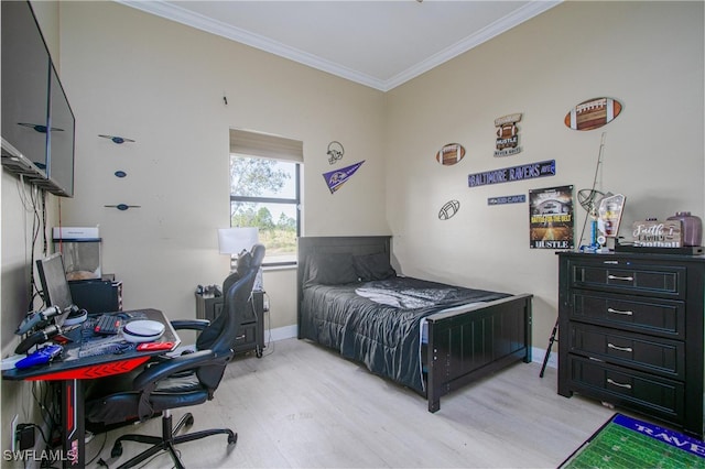 bedroom with crown molding and light hardwood / wood-style flooring