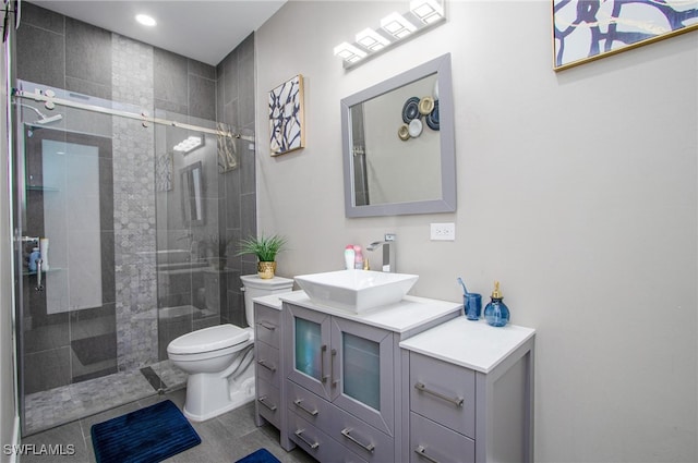 bathroom with tile patterned floors, vanity, toilet, and walk in shower