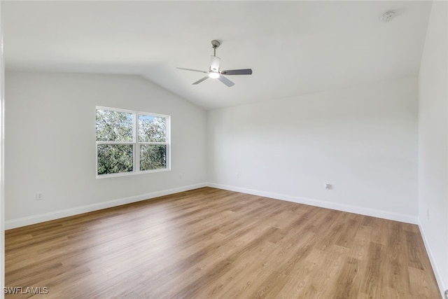 empty room featuring ceiling fan, light hardwood / wood-style floors, and lofted ceiling